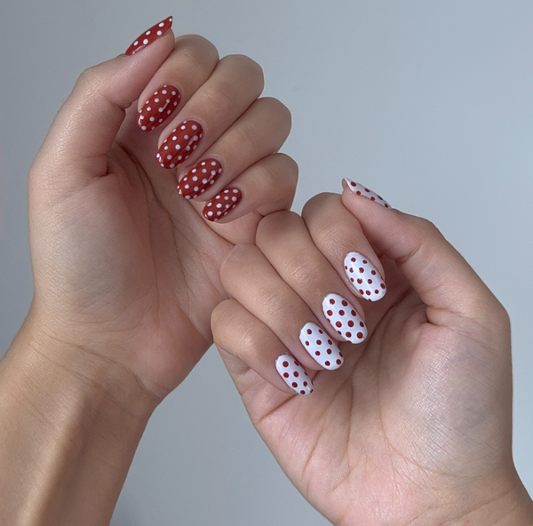polka dot nails using red and white on two hands